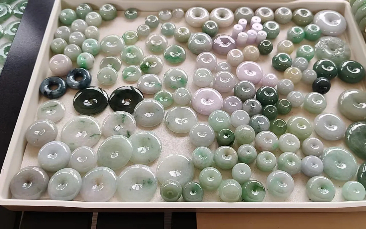 Jadeite ping'an kou (平安扣) peace pendants displayed at Sihui market