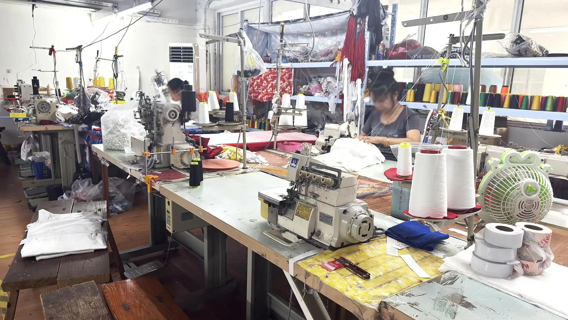 Workers at sewing stations during in-process quality check