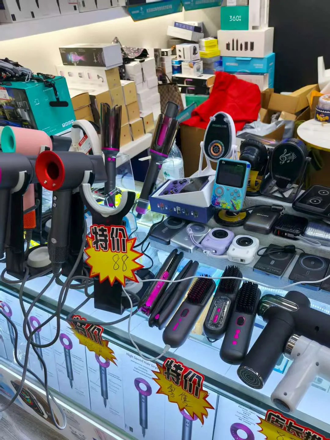 Shelf of consumer electronics including power banks, earphones and small gadgets in Huaqiangbei Huaqiang Plaza